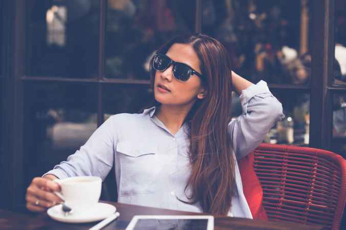 portrait of young woman drinking coffee at home