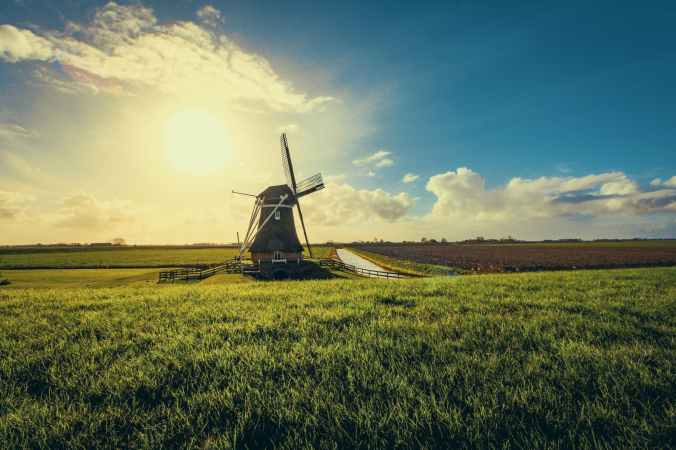 vintage black windmill during sunset