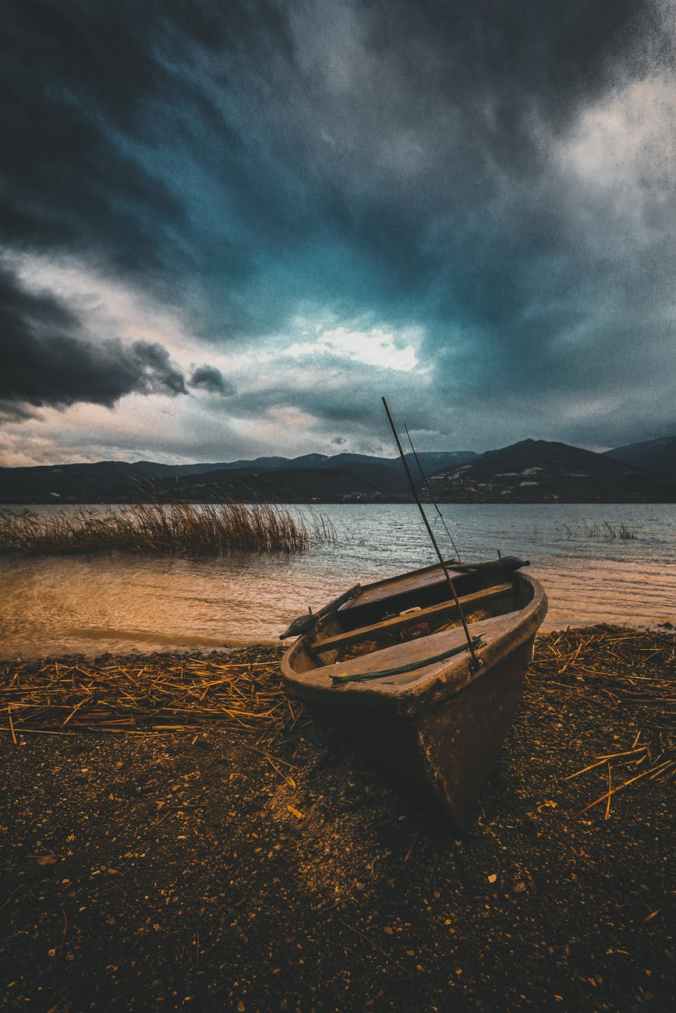 brown boat on beach line